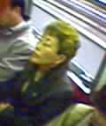 subway woman with a bright yellow-streaked mullet